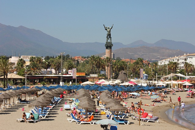 Sunny coastal town in Spain with beach and old buildings