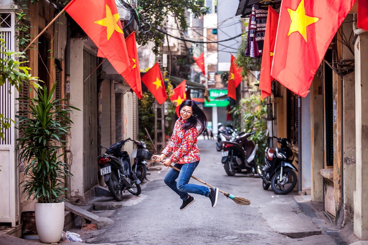 Busy street scene in Hanoi with lights and historic buildings